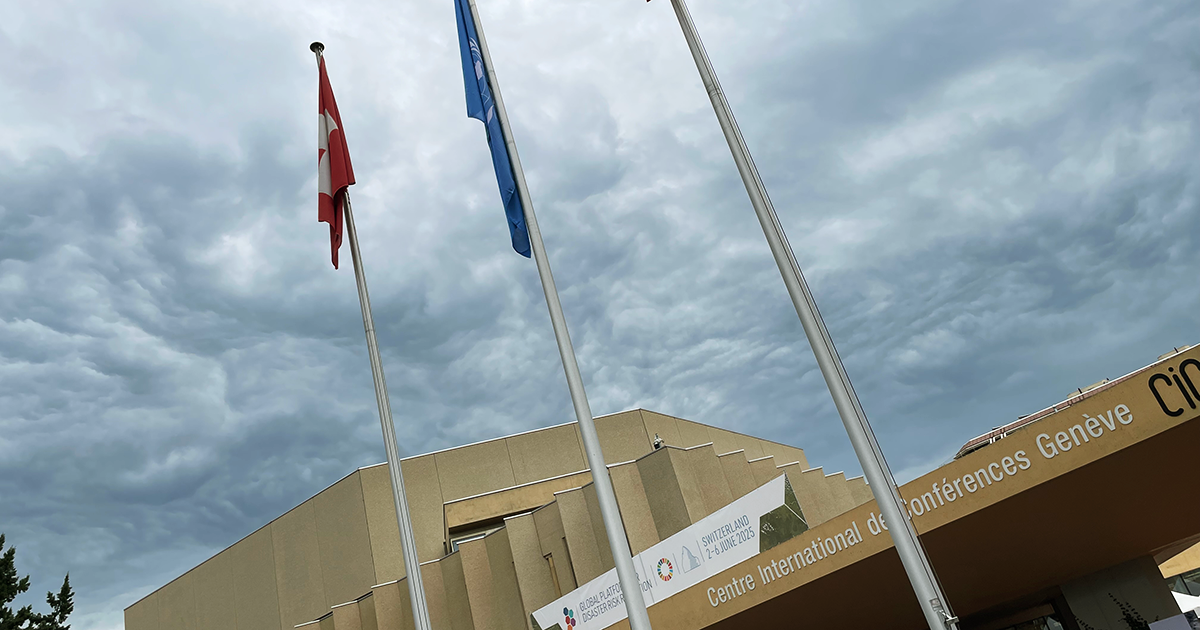 The exterior of the Centre International de Conférences Genève with UN and Swiss flags